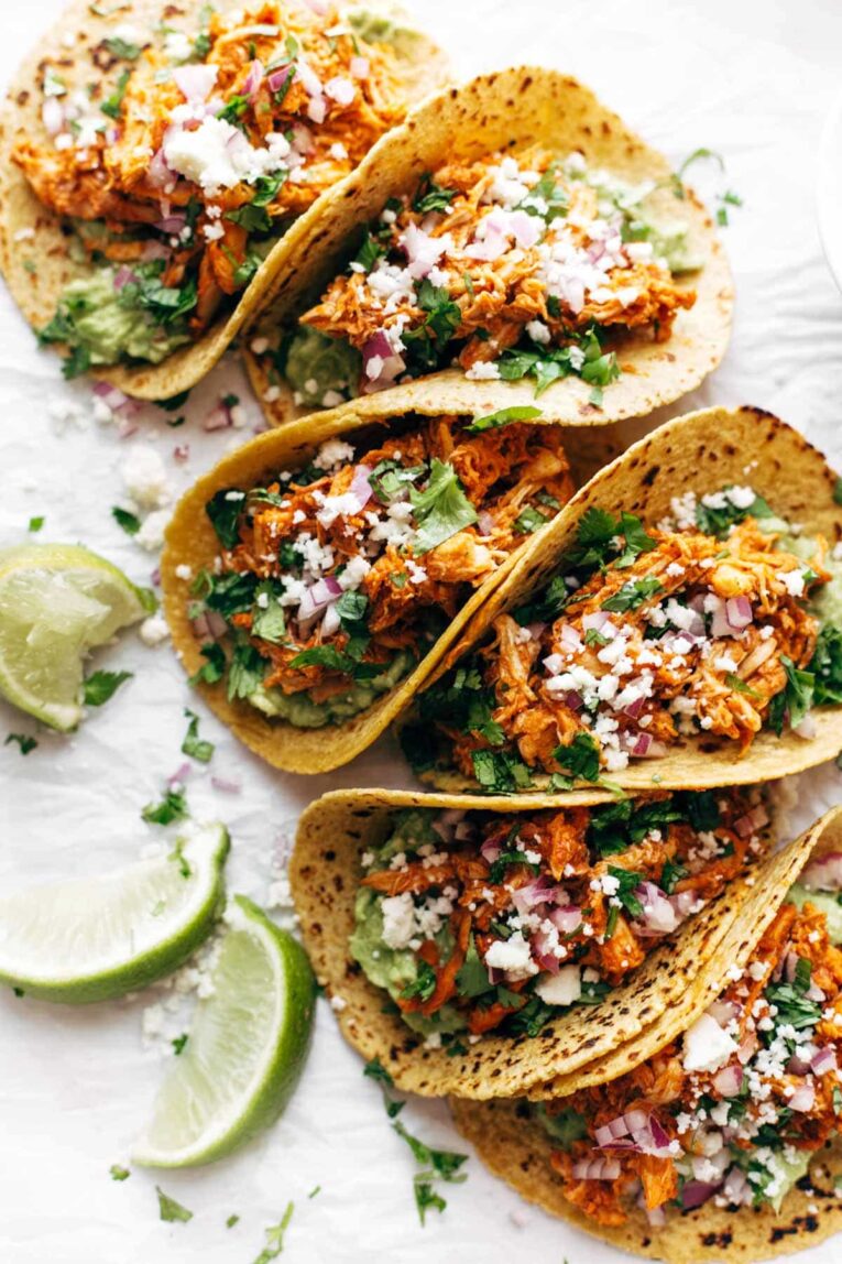 Chicken Tinga Tacos beautifully arranged on a white surface.