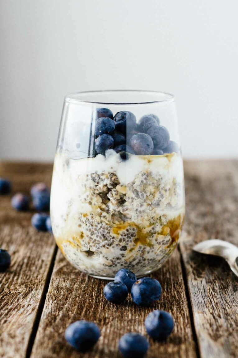 Easy Blueberry Chia Overnight Oats in a glass jar on a wooden surface.