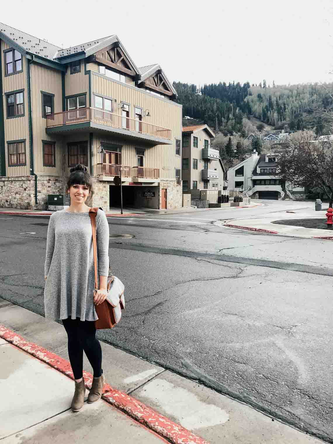 A girl standing in front of Park City outside of Salt Lake City