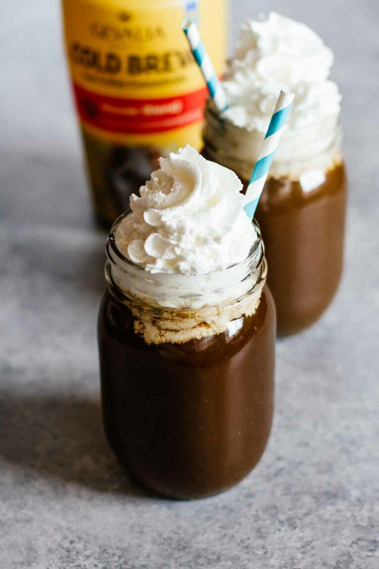 Cold Brew Coffee with whipped cream in two mason jars