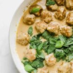 Close up of Swedish meatballs in a saucepan with gravy.