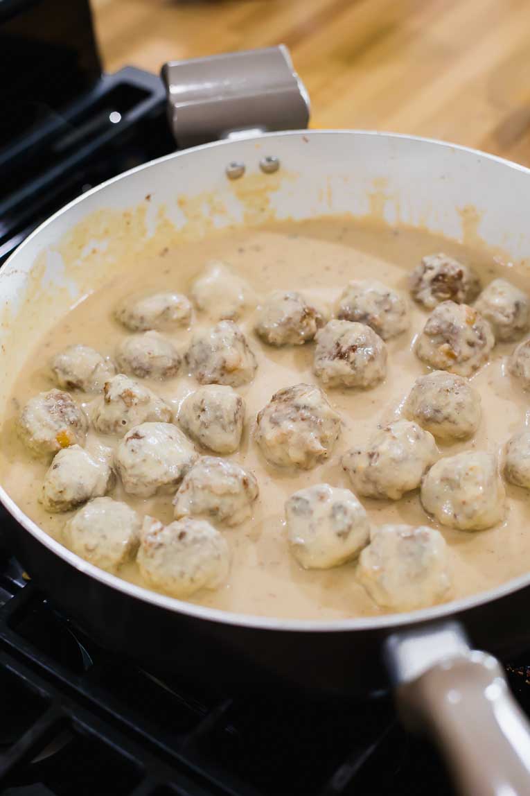 Healthy Turkey Swedish Meatballs with creamy sauce in a saucepan.