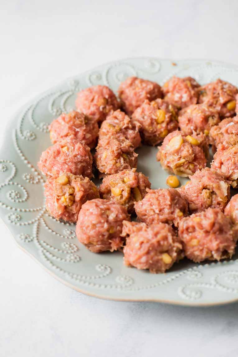 Raw meatballs on a plate.