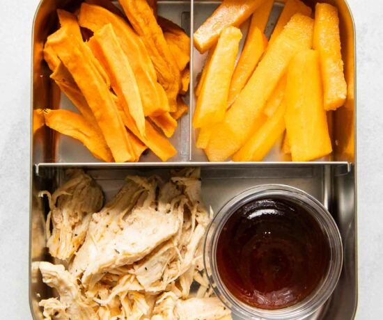 Shredded chicken with barbecue sauce, sweet potato fries, and peaches.