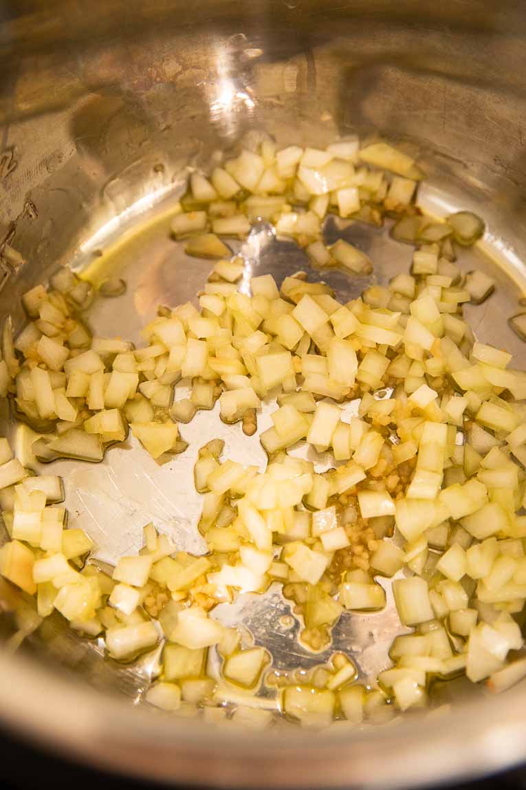 Onions being sautéed in an Instant Pot.