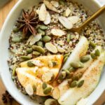 Quinoa breakfast bowl with fall spices and toppings.