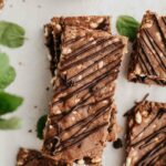 Mint dark chocolate protein bars with mint and chocolate chips on a white background.