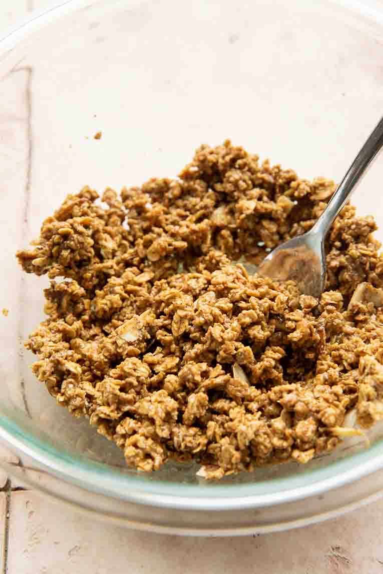 Granola, honey, and peanut butter in a mixing bowl.