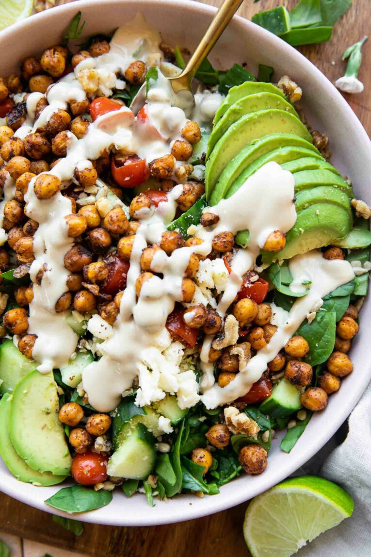 Close up of crispy chickpea salad with chili lime, avocado, and cucumbers.