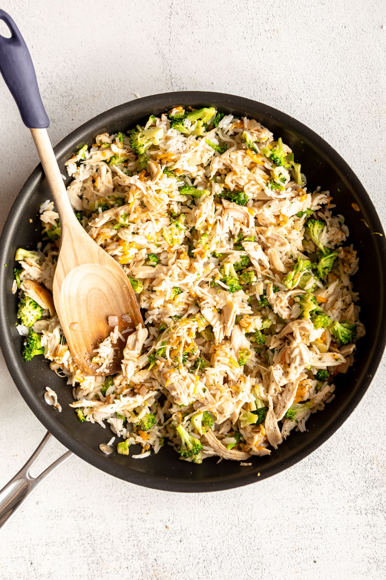Veggies, shredded chicken, and rice in a pan.