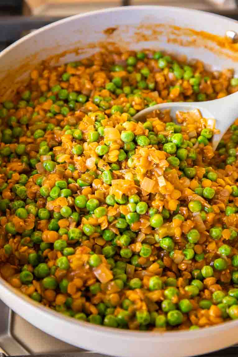 Peas added to veggie mixture in pan for Vegetarian shepherds pie.