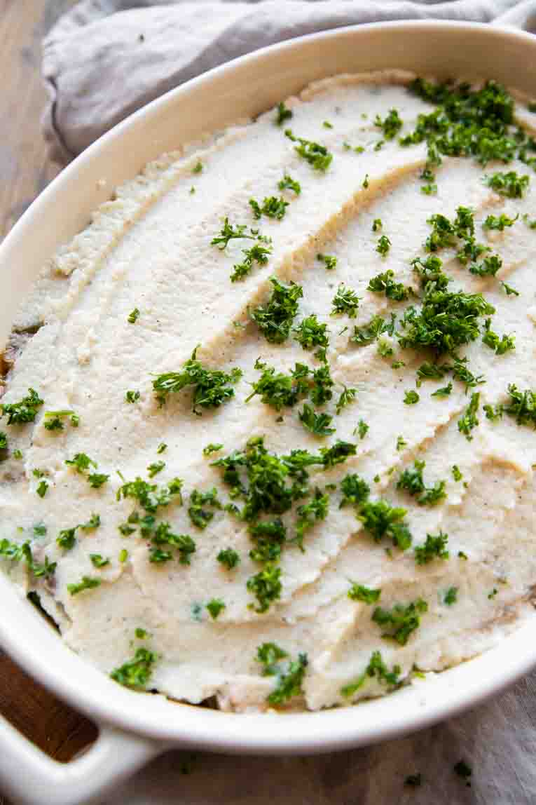 Cauliflower mash on top of lentil mixture in casserole dish.