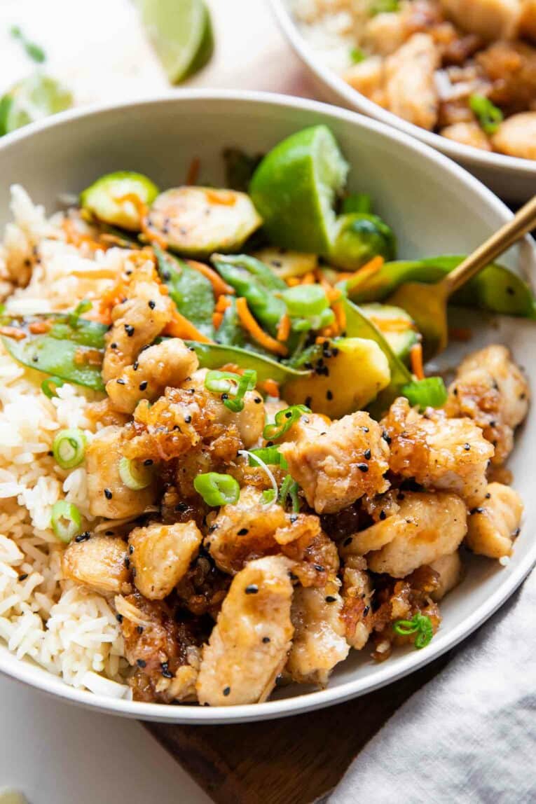 Angled photo of Honey Sesame Chicken in a bowl.