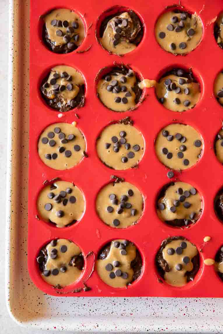 Protein Brownie Bites in a silicone pan with chocolate chips.