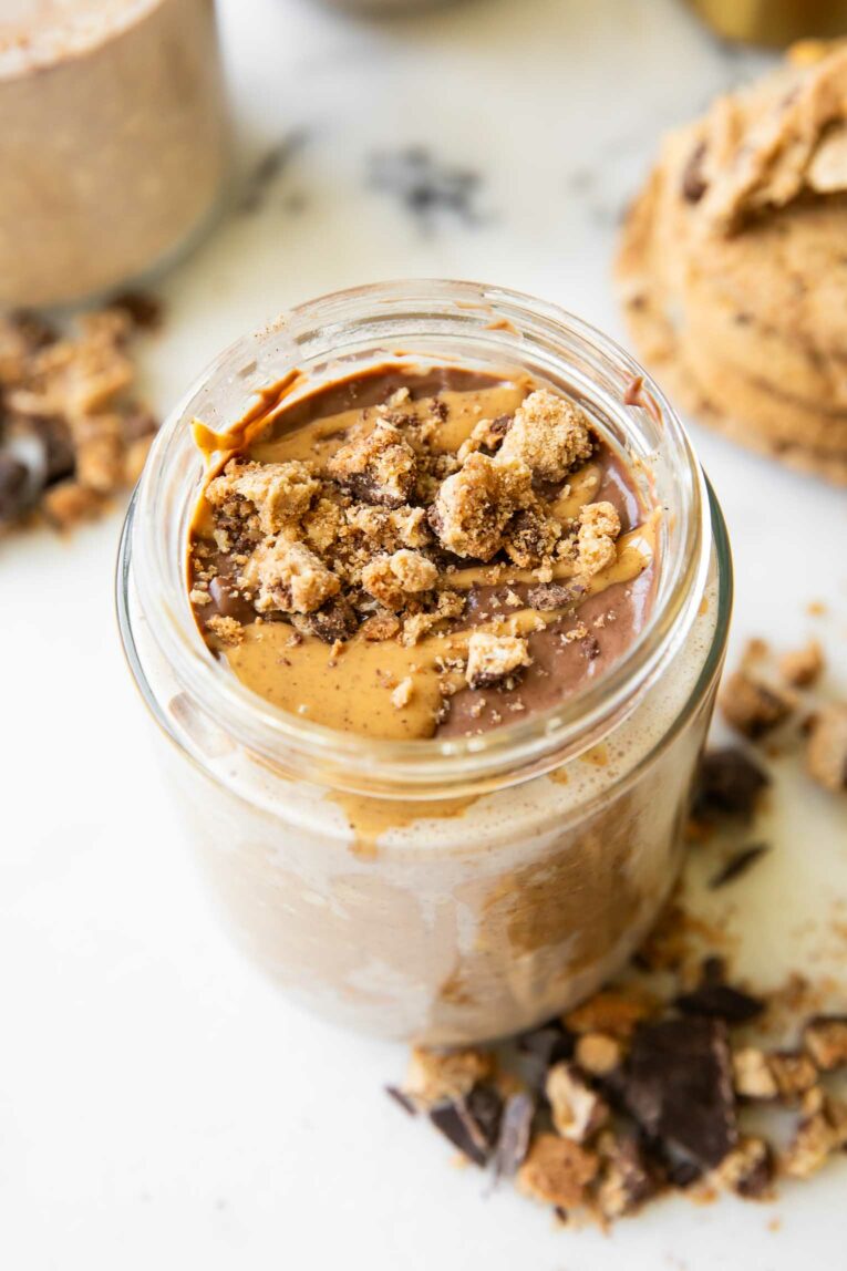 Angled photo of chocolate Peanut Butter Overnight Oats with cookie crumbles.