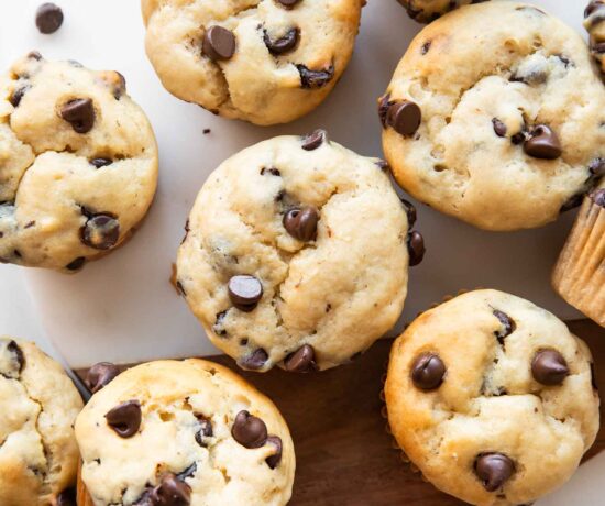 Banana chocolate chip muffins on a cutting board.