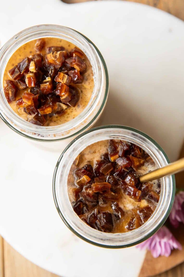 Top view Palm Springs Date Overnight Oats in two mason jars.
