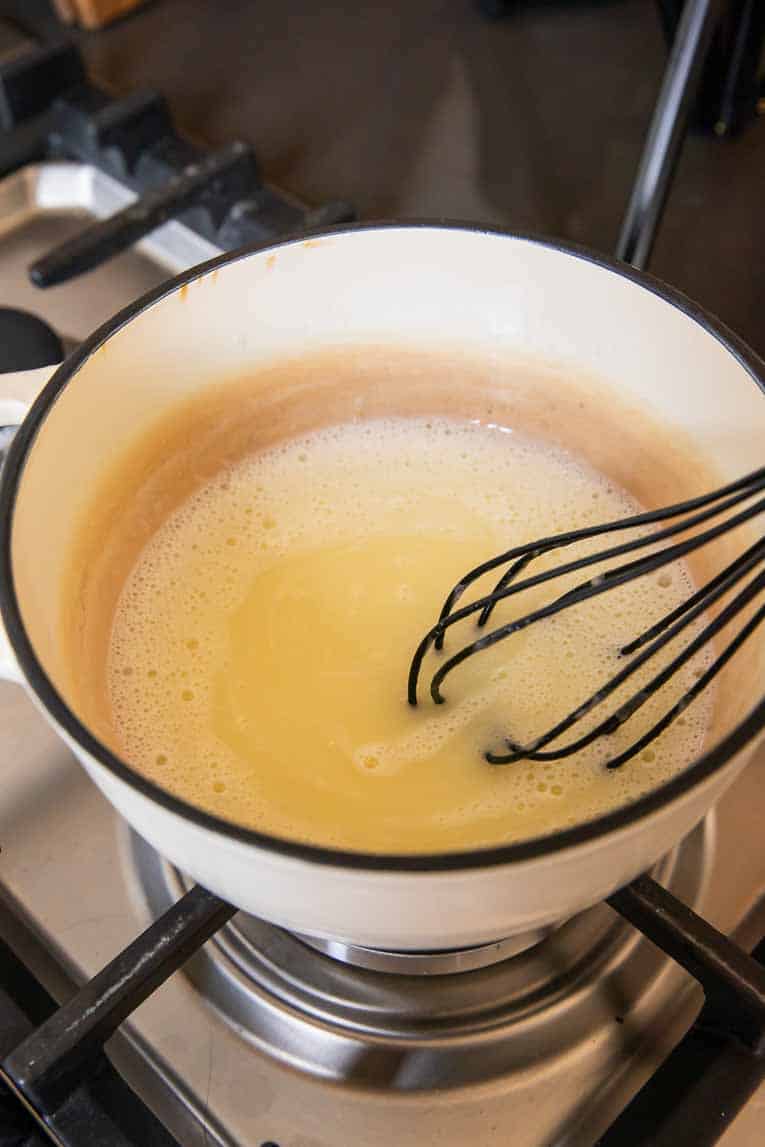 Lemon posset ingredients in a pot.