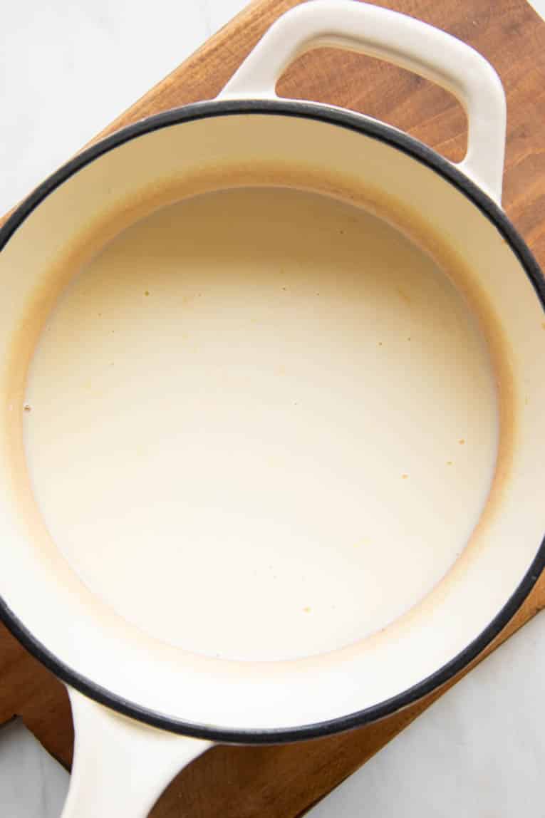 Lemon posset ingredients in a pot.