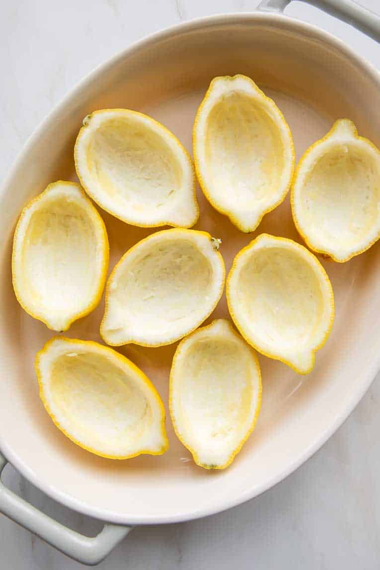 Lemon halves in a dish.