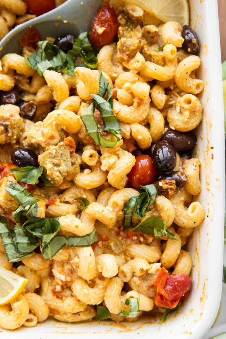 close up image of Mediterranean Chicken Feta Pasta in a baking dish.
