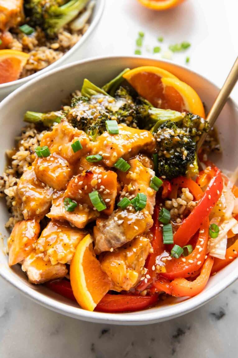 Angled image of orange salmon ginger bowl.
