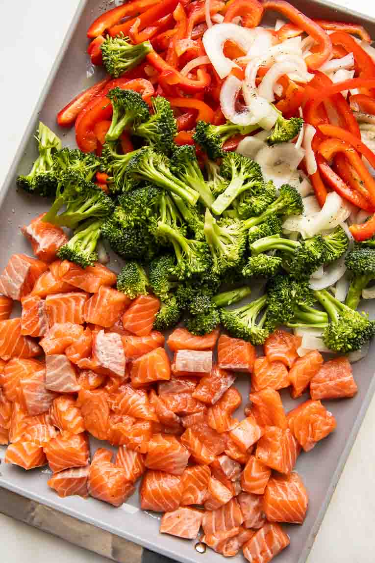 Salmon and veggies on a baking sheet.