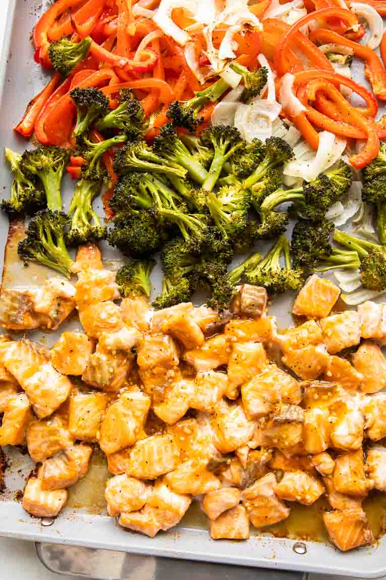 Cooked Salmon and veggies on a baking sheet.