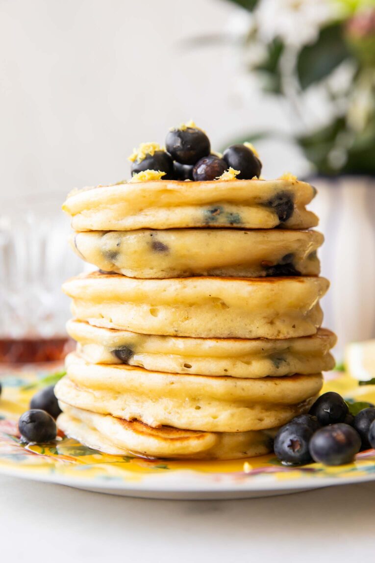 A stack of lemon blueberry muffins on a plate.