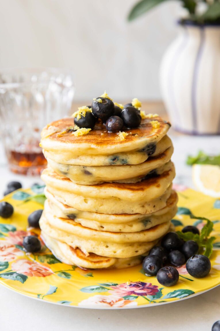 A stack of lemon blueberry muffins on a plate.
