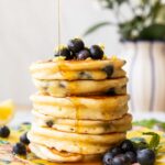 A stack of lemon blueberry muffins on a plate.
