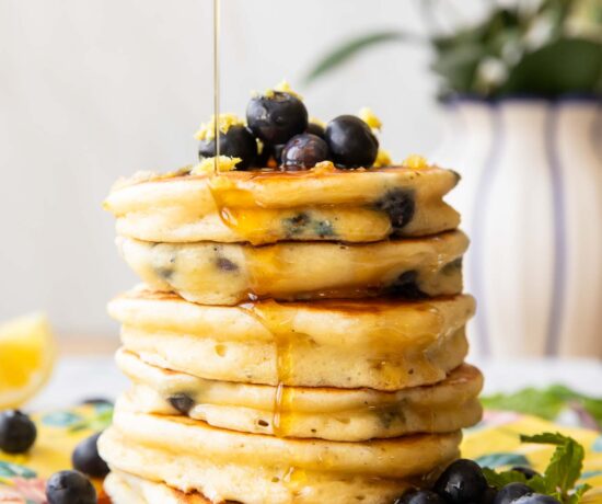 A stack of lemon blueberry muffins on a plate.