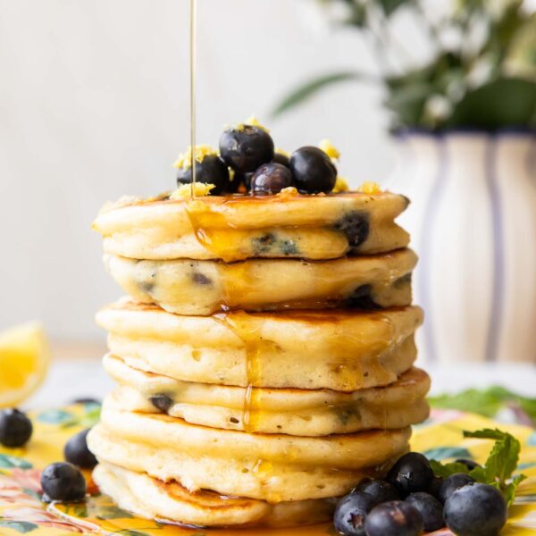 A stack of lemon blueberry muffins on a plate.