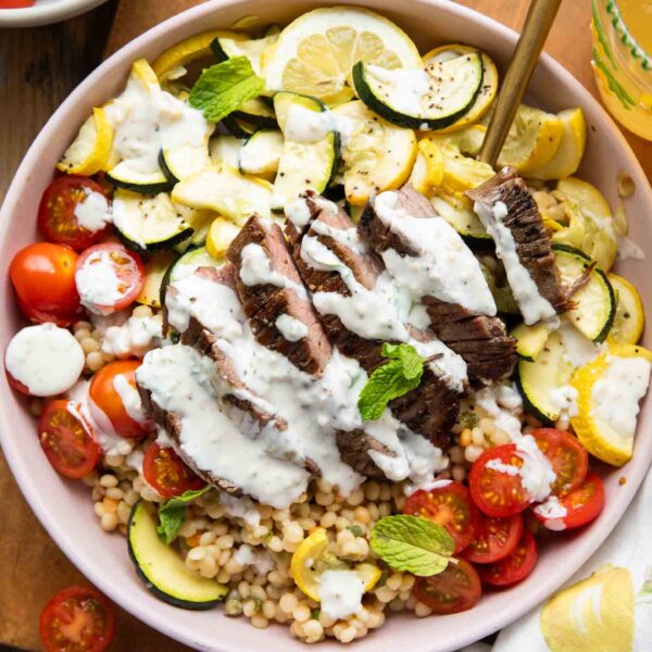 Steak Couscous Bowl on a cutting board.