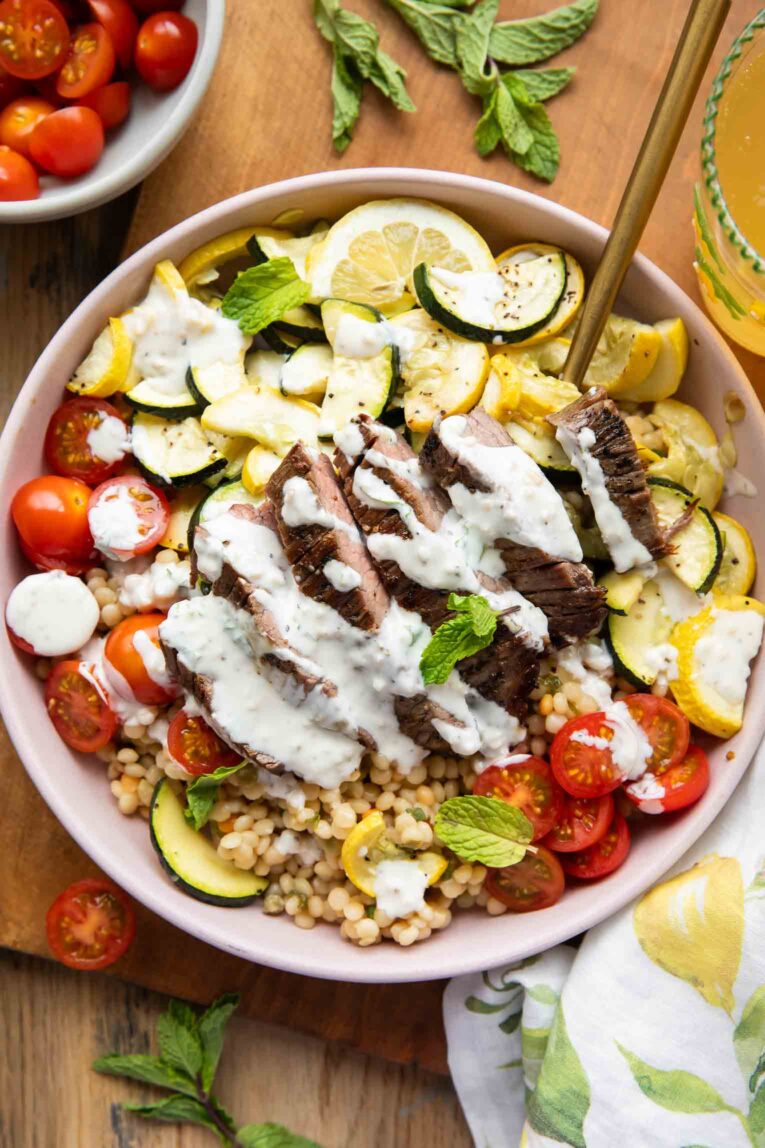Steak Couscous Bowl on a cutting board.