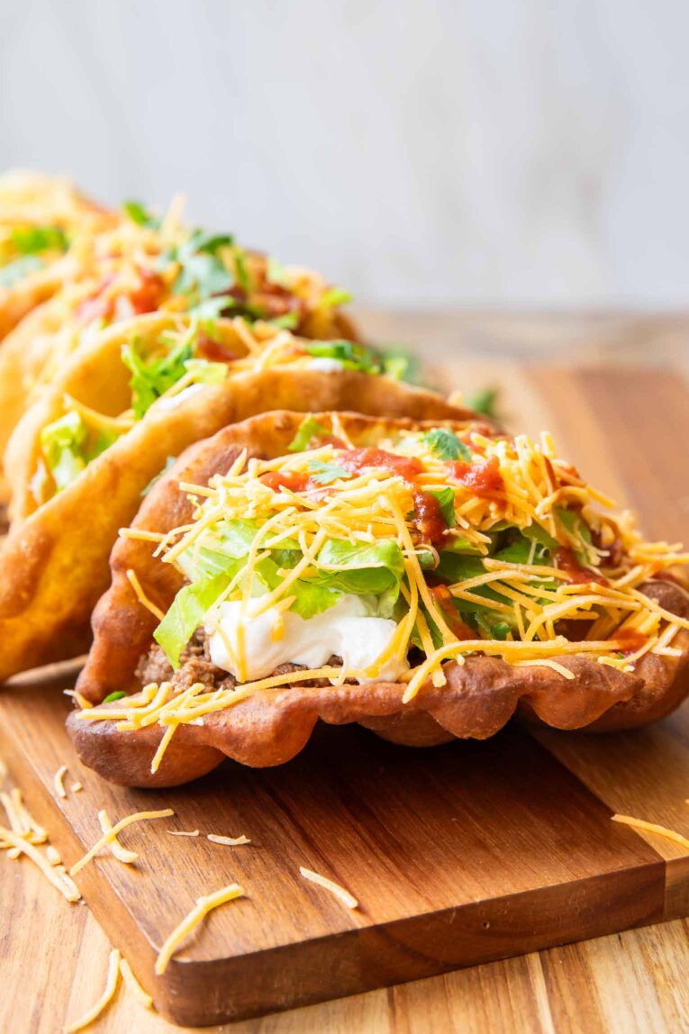 Taco Bell Chalupas on a cutting board.