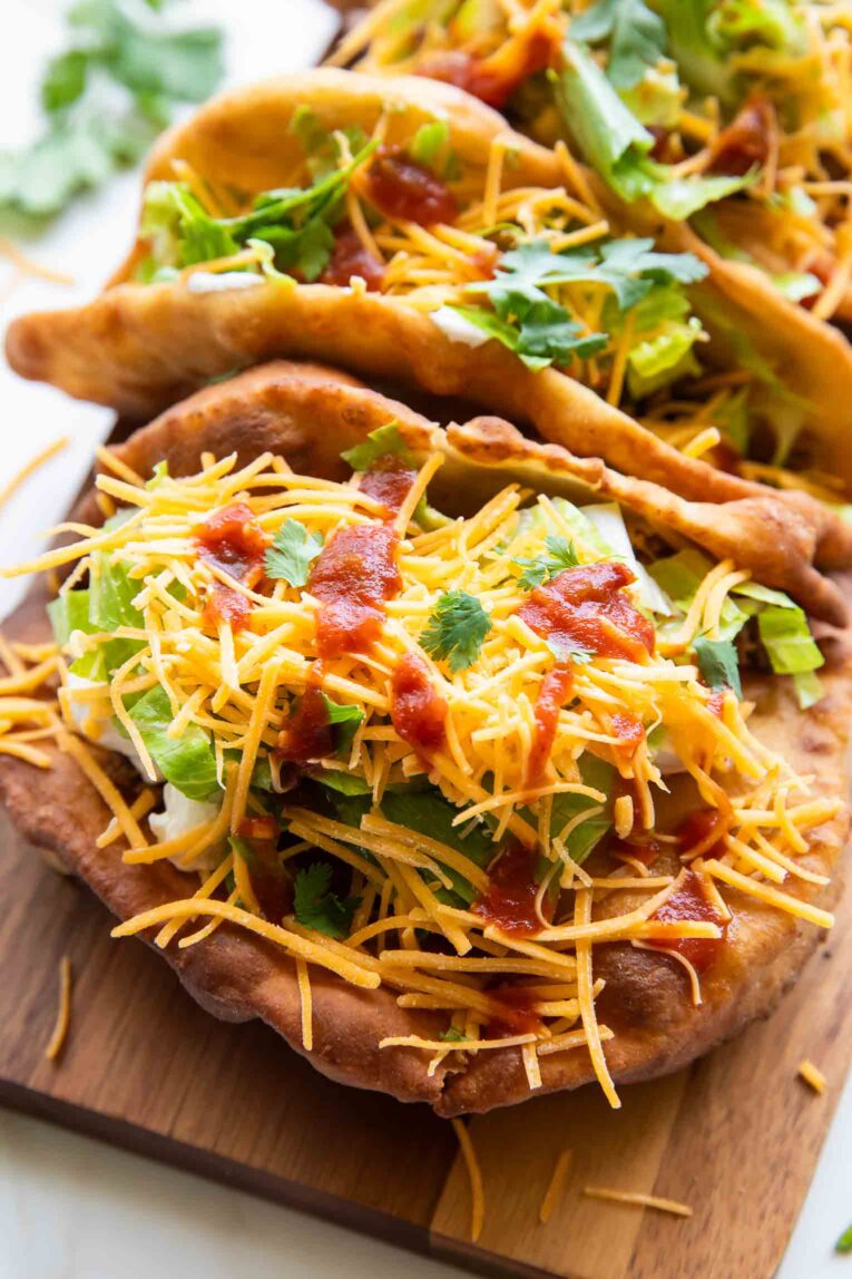 Top view of Taco Bell Chalupas on a cutting board.