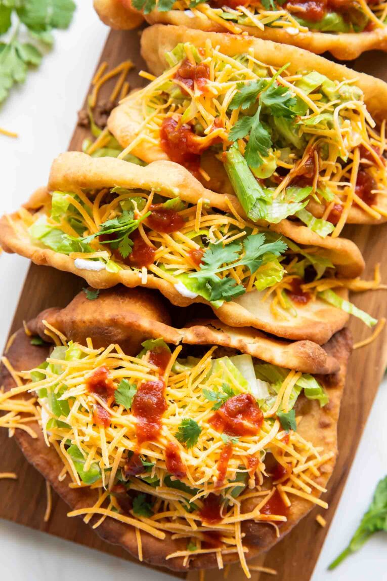 Top view of Taco Bell Chalupas on a cutting board.