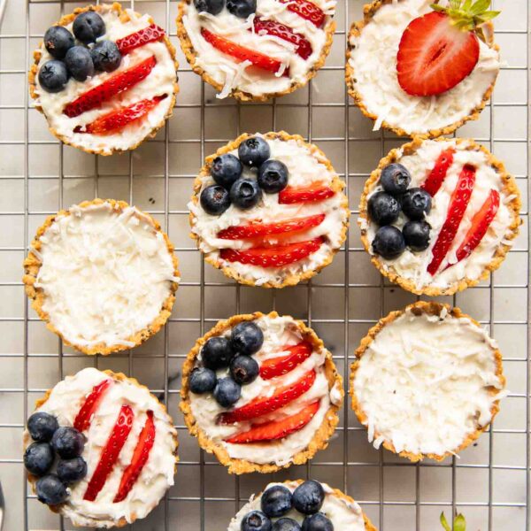Patriotic fruit tarts on a cooling rack.