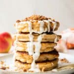 A stack of apple struesel pancakes on a plate.