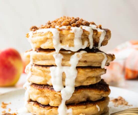 A stack of apple struesel pancakes on a plate.