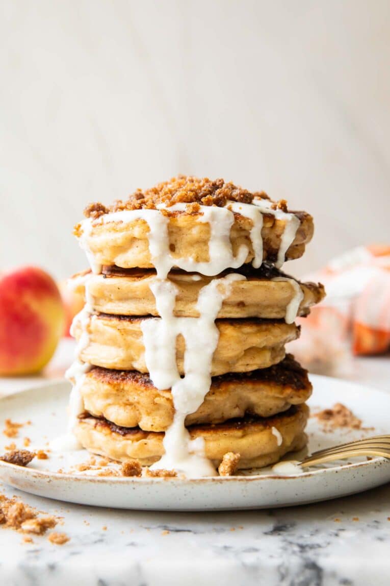 A stack of apple struesel pancakes on a plate.