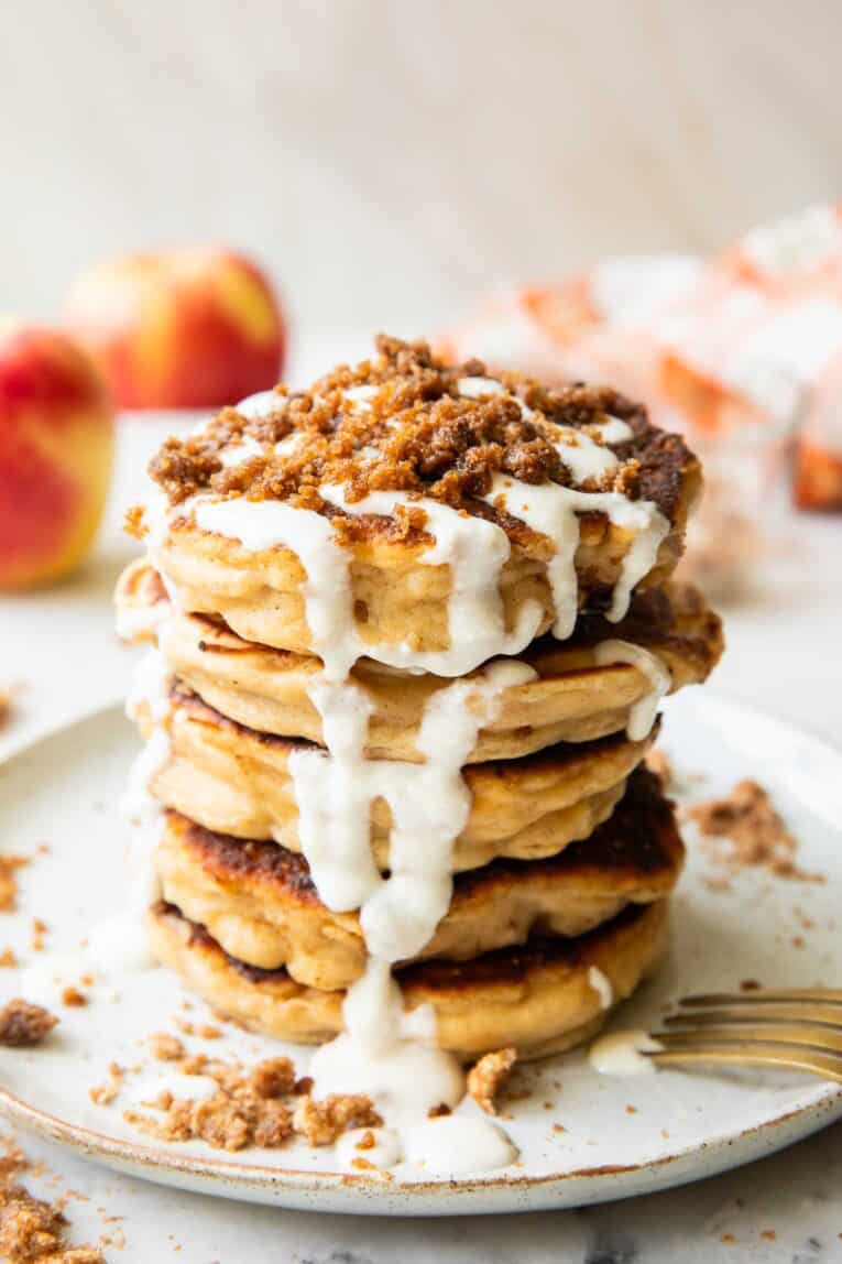 A stack of apple struesel pancakes on a plate.