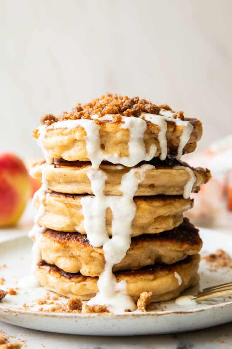 A stack of apple struesel pancakes on a plate.