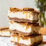 Biscoff cottage cheese cheesecake bars stacked on top of each other.