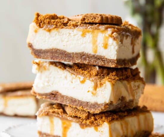 Biscoff cottage cheese cheesecake bars stacked on top of each other.