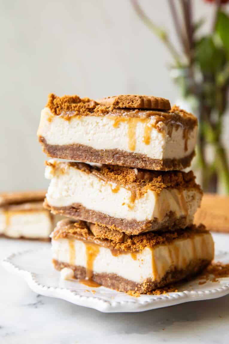 Biscoff cottage cheese cheesecake bars stacked on top of each other.