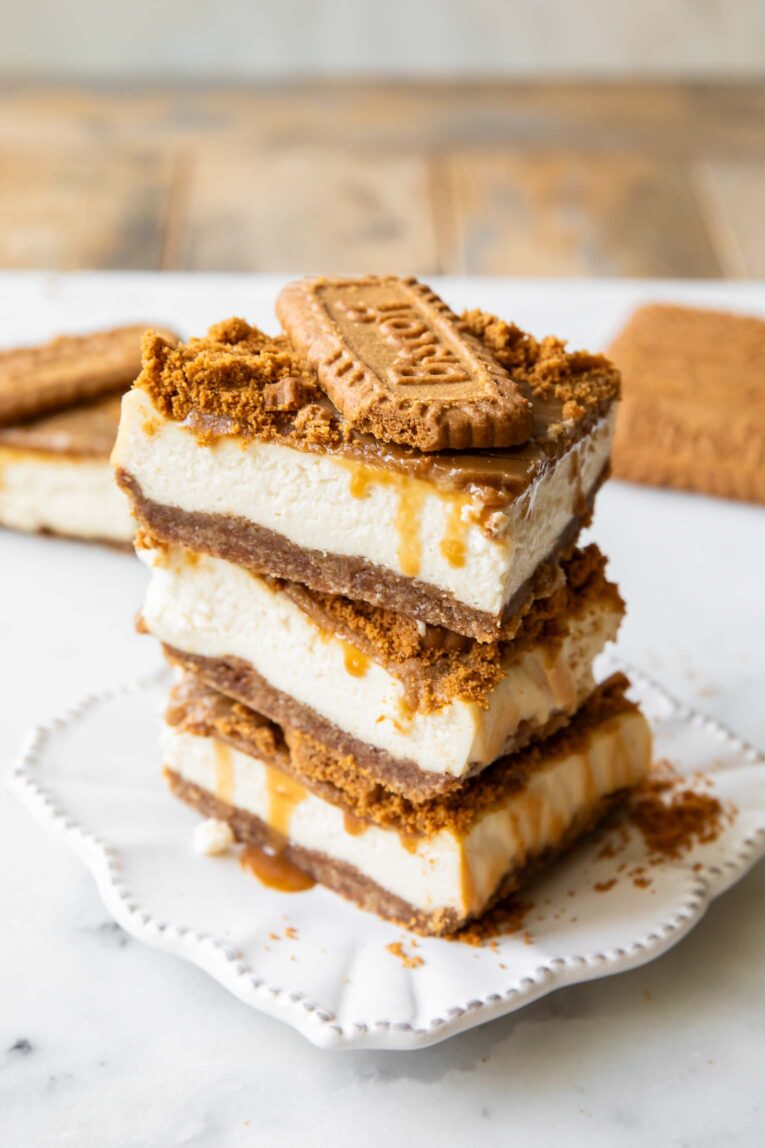 Biscoff cottage cheese cheesecake bars stacked on top of each other.