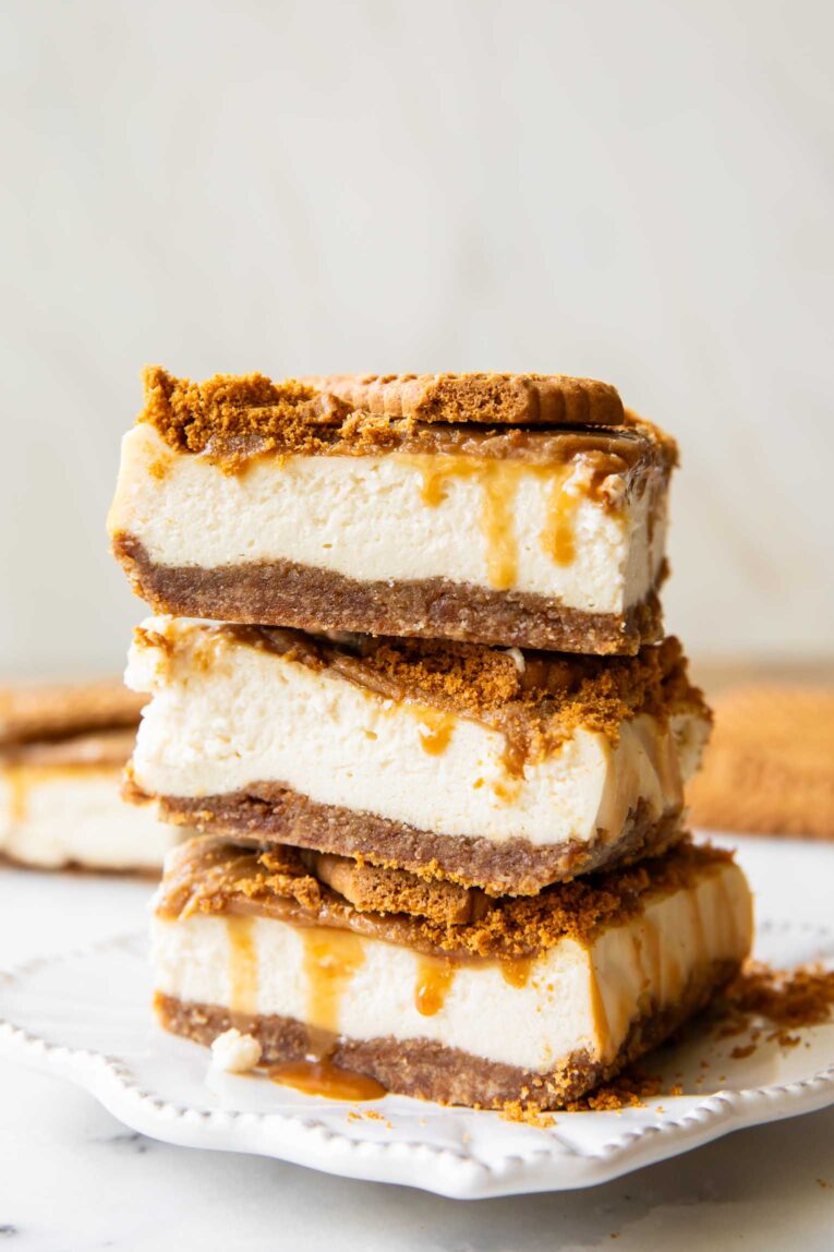 Biscoff cottage cheese cheesecake bars stacked on top of each other.