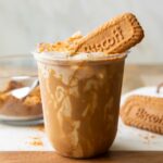 Iced Biscoff latte in a clear cup.